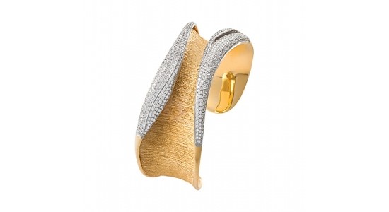 A mixed metal cuff bracelet with diamond accents from JYE, available at Rogers Jewelry Co.