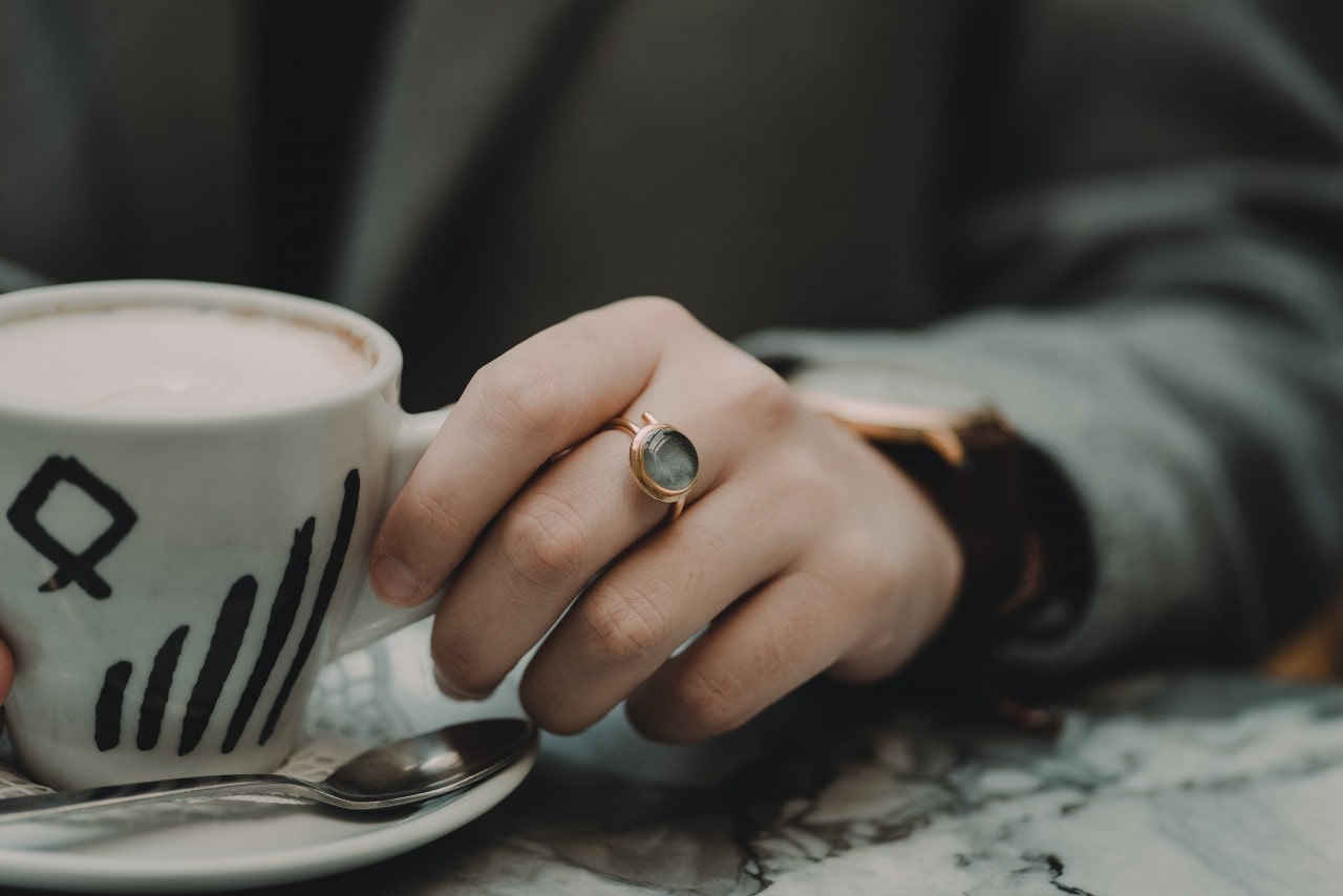 Stylish individual donning a chic gold fashion ring