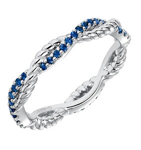 A vintage inspired 14k white gold wedding band features intertwining bands, one with a rope pattern and one with prong set sapphires