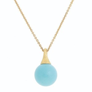 This minimalist, 18k yellow gold pendant from Marco Bicego features a turquoise sphere and cable chain