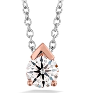 This solitaire pendant from Hearts On Fire has a rose gold accent