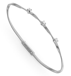 This twisting diamond bangle bracelet is featured in Marco Bicego’s Marrakech collection