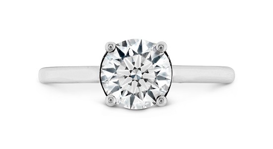A silver solitaire engagement ring with a round cut center stone