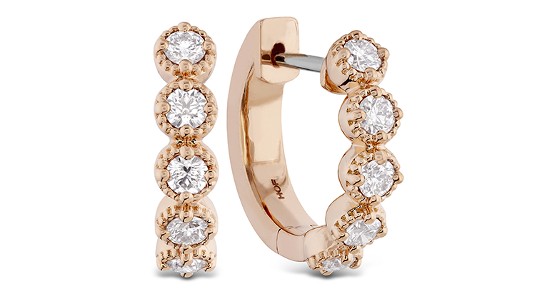 a pair of rose gold, diamond huggies earrings by Hearts On Fire.