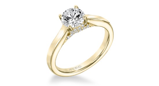 A yellow gold, solitaire engagement ring with diamond detail below the center stone