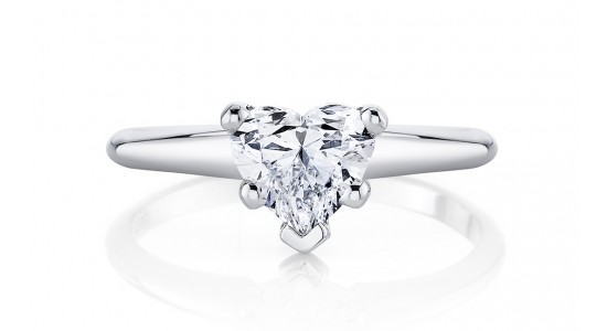A solitaire engagement ring featuring a heart-shaped center stone and a a platinum band