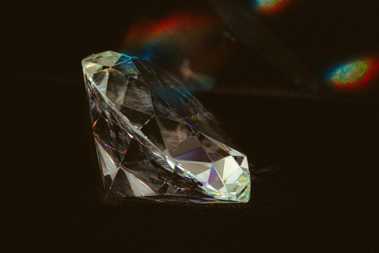 close up image of a round cut diamond against a black background
