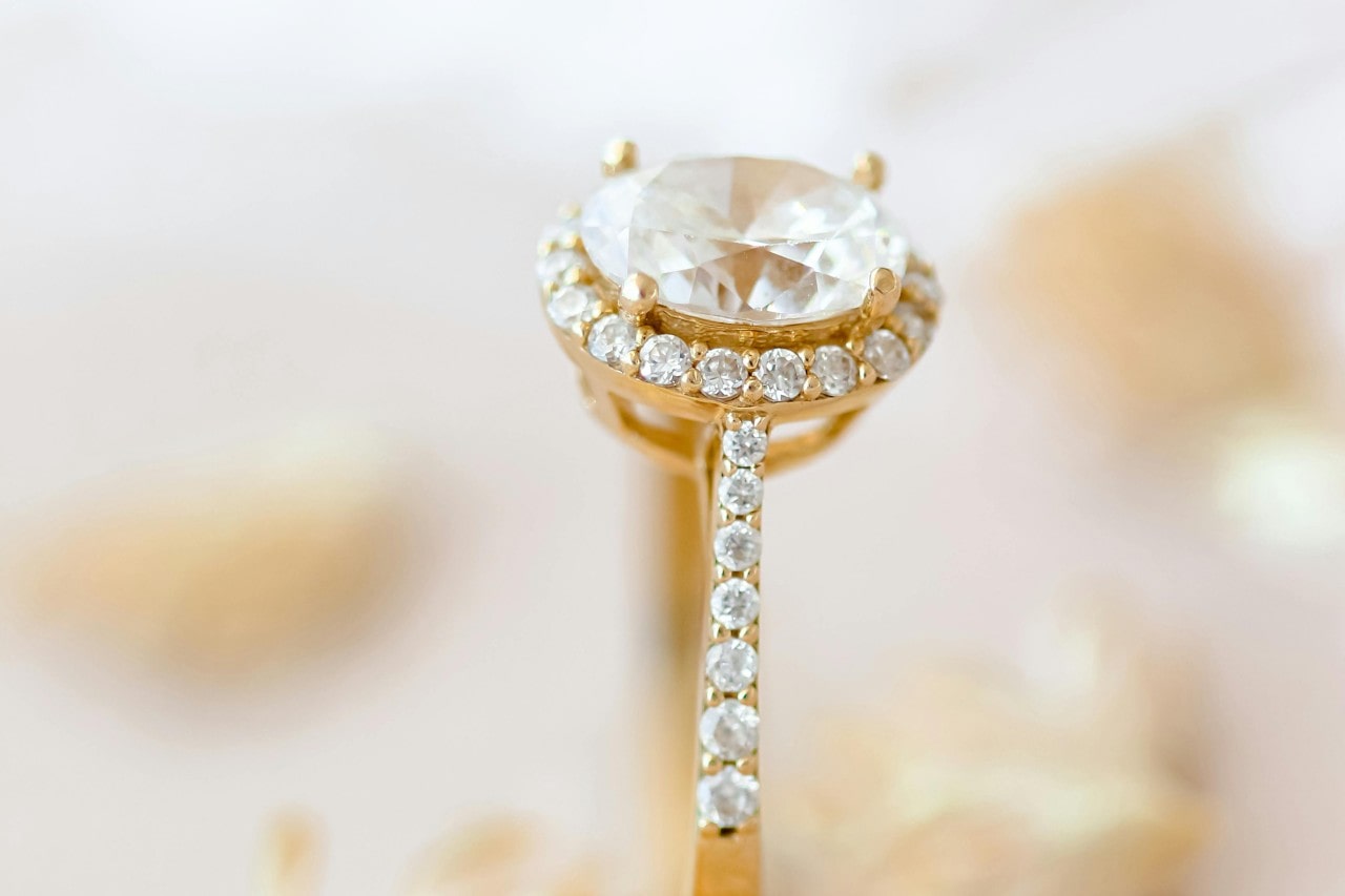 a yellow gold oval cut halo engagement ring