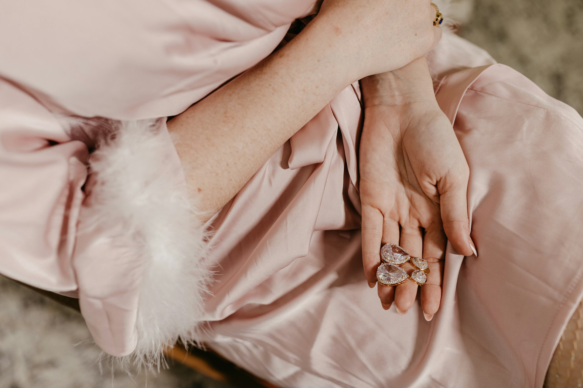 a lady holding diamond earrings