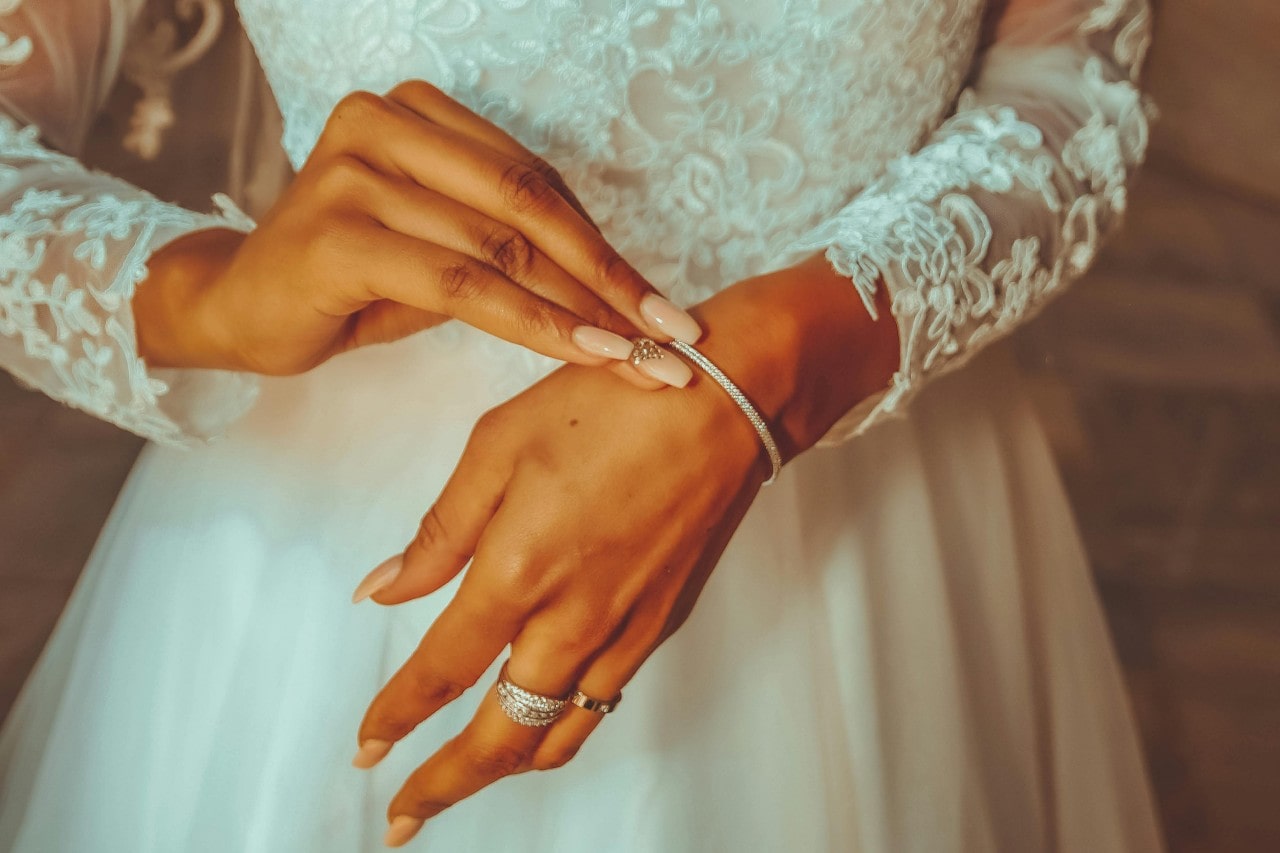 bride putting on a diamond bracelet