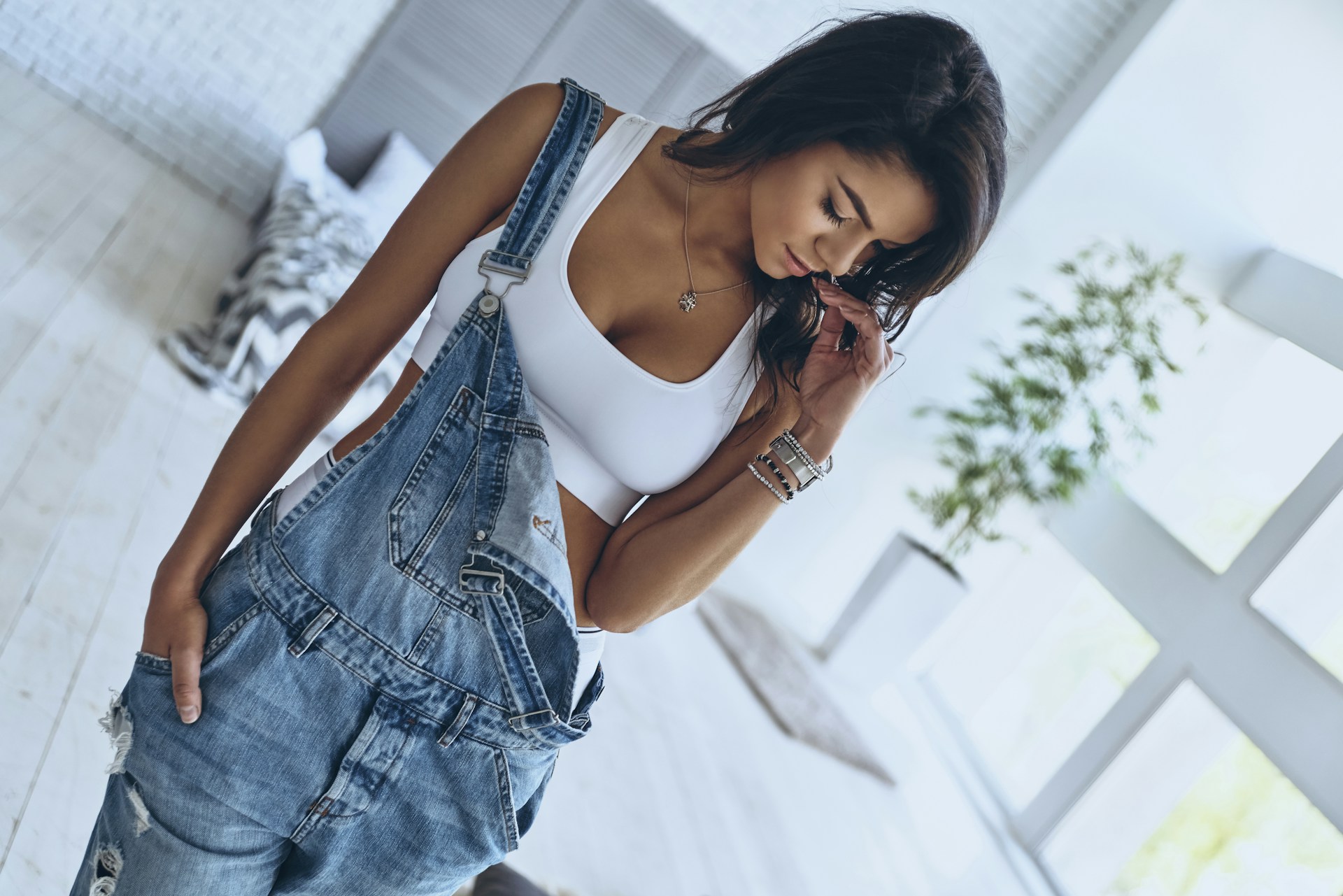 a lady wearing overalls and luxury bracelets