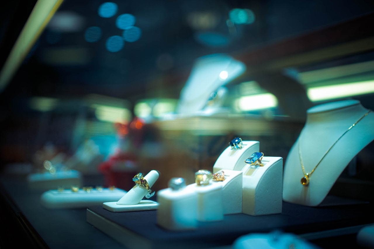 An elegant jewelry store display in low lighting.